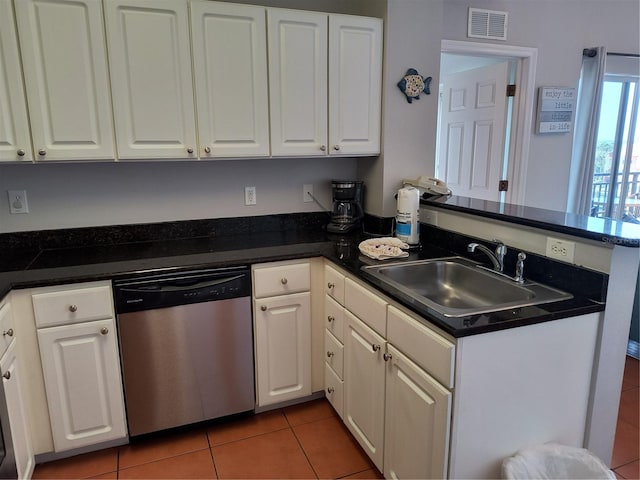 kitchen with visible vents, stainless steel dishwasher, a sink, light tile patterned floors, and a peninsula