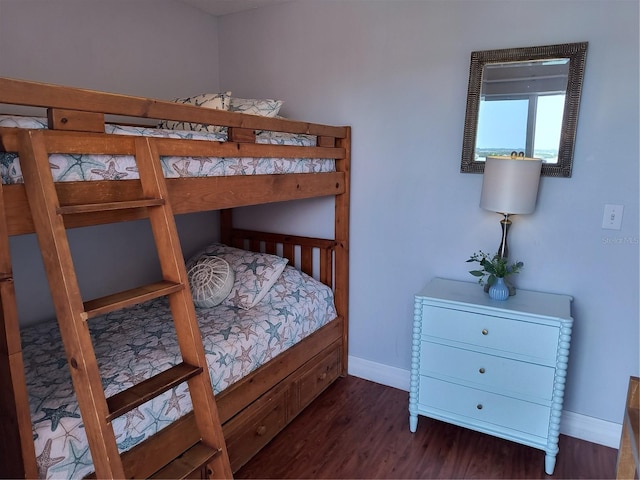 bedroom featuring baseboards and wood finished floors