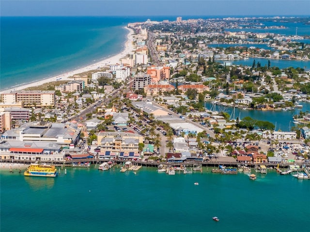 aerial view with a beach view, a water view, and a view of city