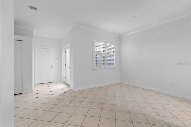 empty room with visible vents, ornamental molding, and baseboards