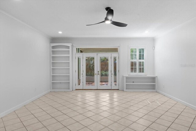 interior space with french doors, a ceiling fan, baseboards, and crown molding