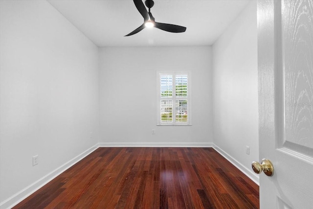 unfurnished room featuring baseboards, a ceiling fan, and dark wood-style flooring