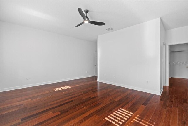 interior space featuring visible vents, a ceiling fan, baseboards, and wood finished floors