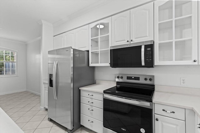 202 S Lincoln Ave, Tampa, FL 33609 - kitchen with appliances with stainless steel finishes, white cabinetry, ornamental molding, and glass insert cabinets