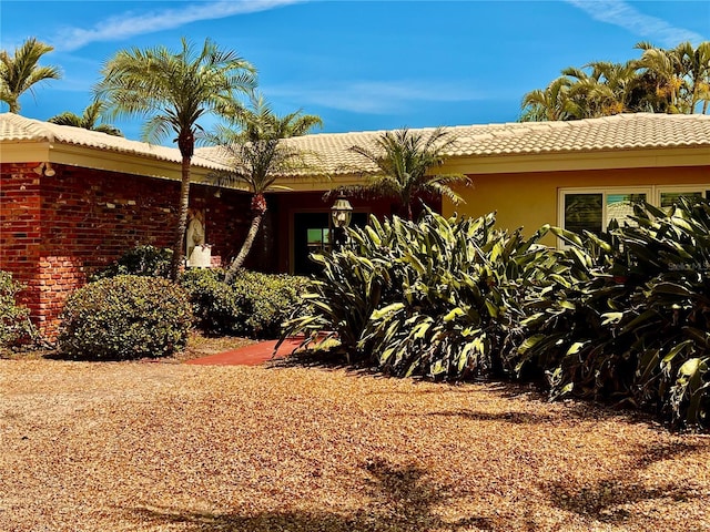 view of front of property featuring a tiled roof and stucco siding