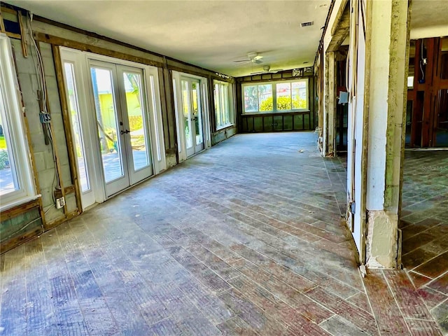 unfurnished sunroom with french doors