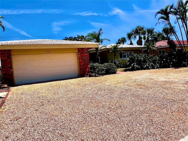ranch-style home with brick siding and driveway