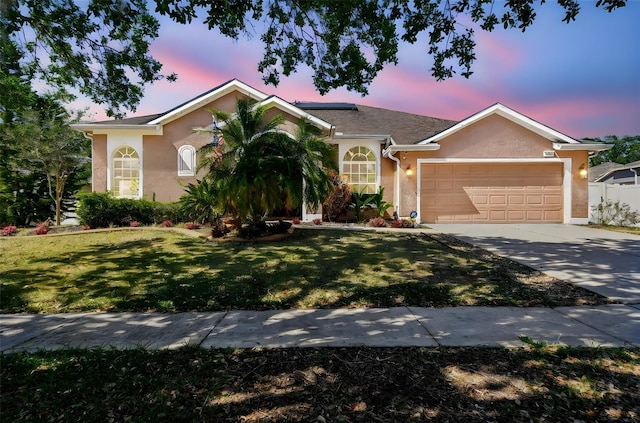 1939 Heartland Cir, Valrico, FL 33594 - ranch-style house with a lawn, a garage, roof mounted solar panels, concrete driveway, and stucco siding