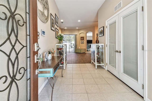 1939 Heartland Cir, Valrico, FL 33594 - foyer entrance with french doors, visible vents, arched walkways, light tile patterned floors, and recessed lighting