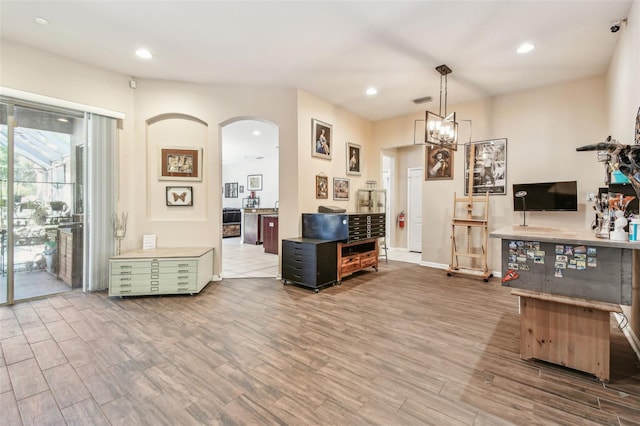 1939 Heartland Cir, Valrico, FL 33594 - dining area featuring recessed lighting, arched walkways, wood finished floors, and a notable chandelier