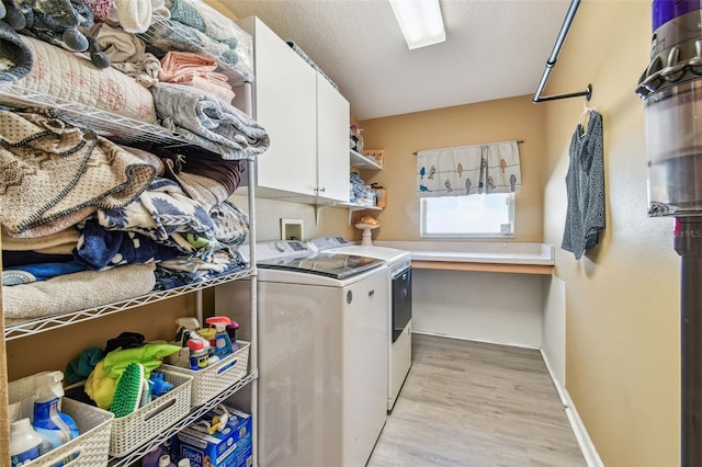1939 Heartland Cir, Valrico, FL 33594 - laundry room featuring light wood-style floors, baseboards, cabinet space, and independent washer and dryer