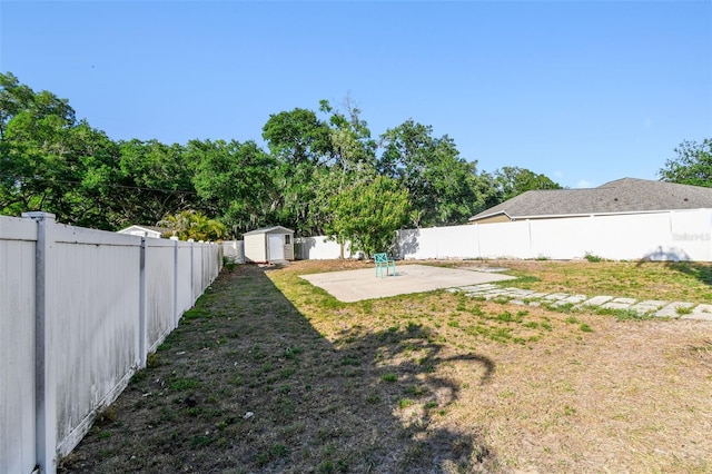 1939 Heartland Cir, Valrico, FL 33594 - view of yard with a storage unit, a fenced backyard, an outbuilding, and a patio