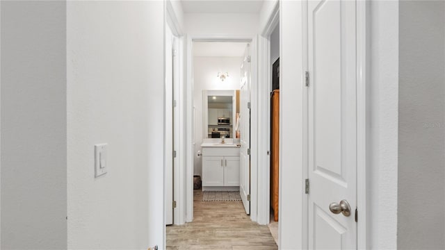 5735 Mezzana Run, Palmetto, FL 34221 - corridor featuring light wood finished floors