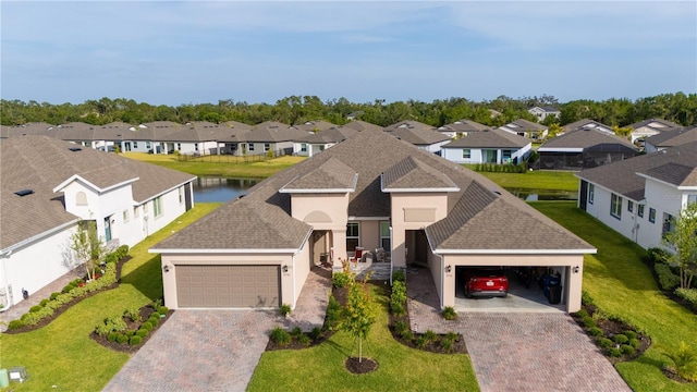 5735 Mezzana Run, Palmetto, FL 34221 - view of front facade with a residential view, driveway, a front yard, and stucco siding