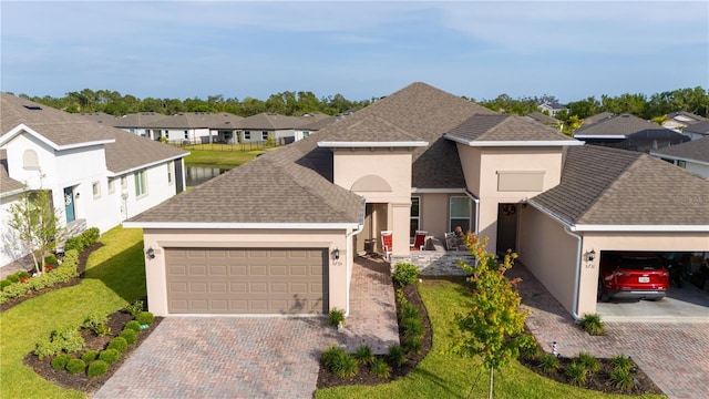5735 Mezzana Run, Palmetto, FL 34221 - view of front of property featuring an attached garage, driveway, a residential view, and stucco siding