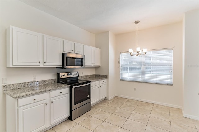 kitchen with appliances with stainless steel finishes, a chandelier, white cabinets, baseboards, and hanging light fixtures