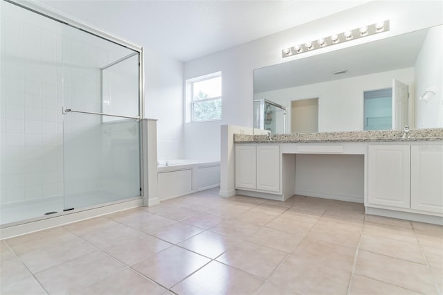 full bath with a shower stall, tile patterned floors, a bath, and vanity