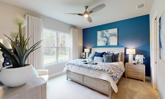 bedroom featuring ceiling fan, carpet floors, visible vents, and baseboards