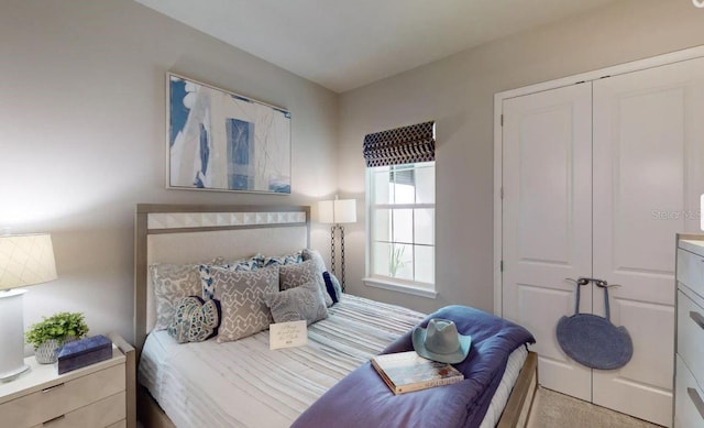 bedroom with light colored carpet and a closet