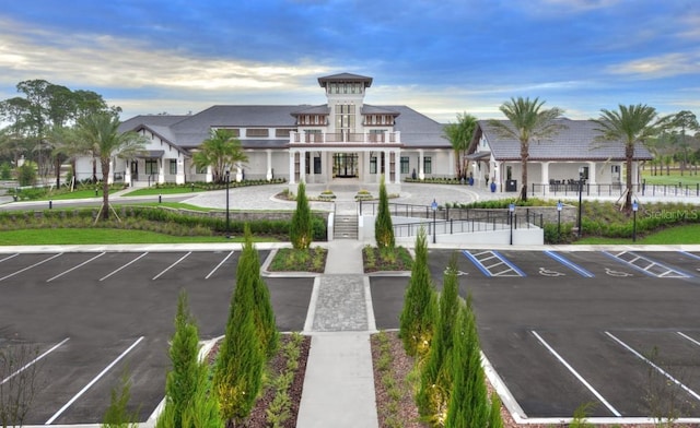 view of property with uncovered parking and fence