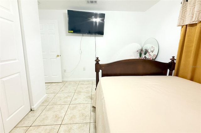 bedroom with light tile patterned flooring, baseboards, and visible vents