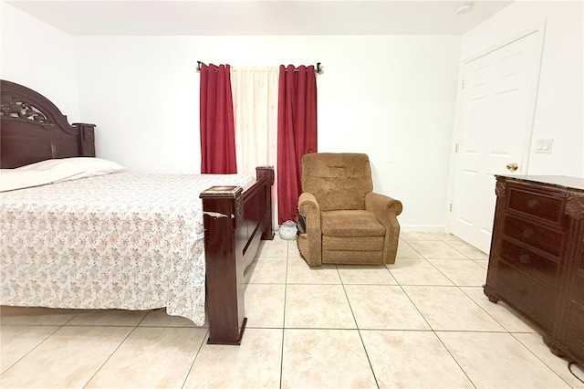 bedroom featuring baseboards and light tile patterned floors