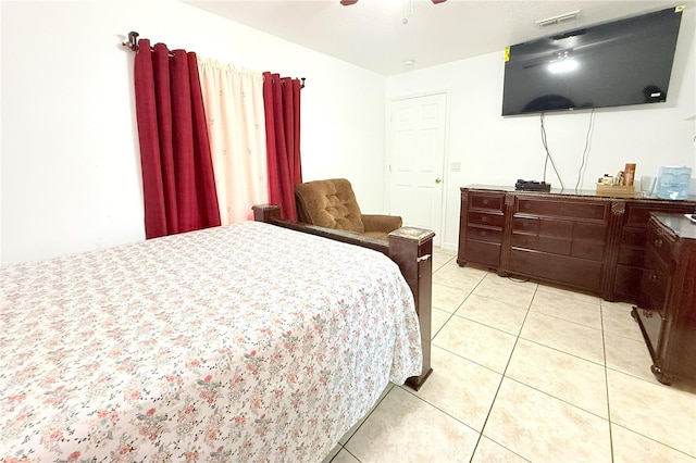 bedroom with ceiling fan, visible vents, and light tile patterned floors