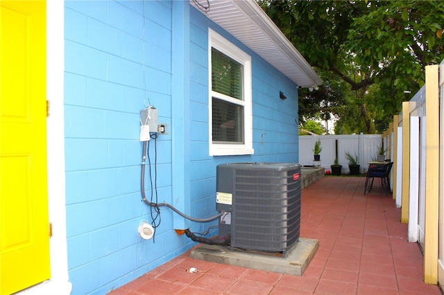 exterior space featuring central AC and fence