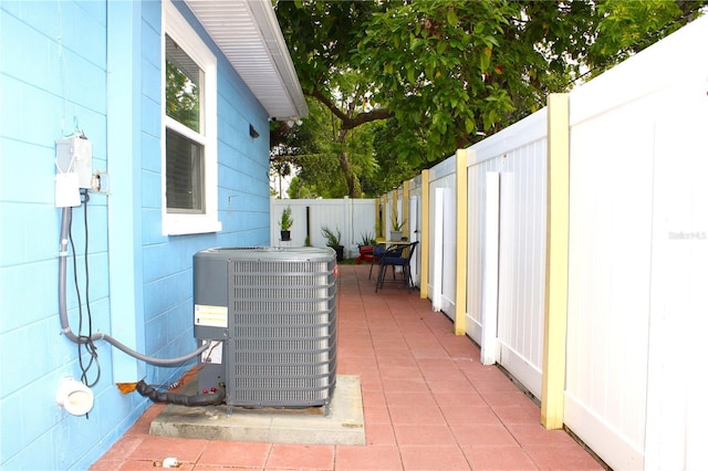 exterior details featuring central AC unit and a fenced backyard