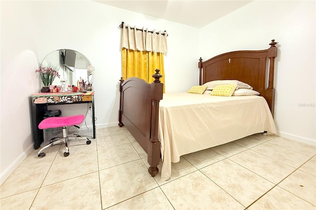 bedroom with light tile patterned flooring and baseboards