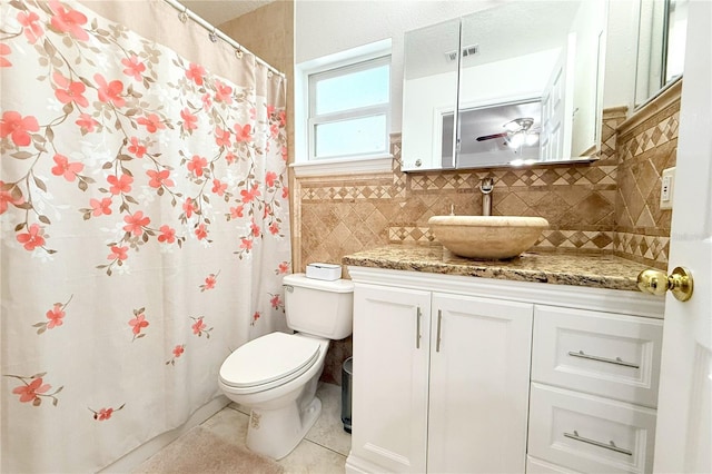 full bathroom featuring tile patterned flooring, visible vents, vanity, toilet, and backsplash