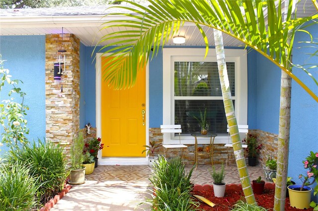 3306 E Chelsea St, Tampa, FL 33610 - entrance to property with covered porch, stucco siding, and stone siding