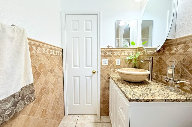 3306 E Chelsea St, Tampa, FL 33610 - full bath with vanity, tile patterned floors, tile walls, and a wainscoted wall