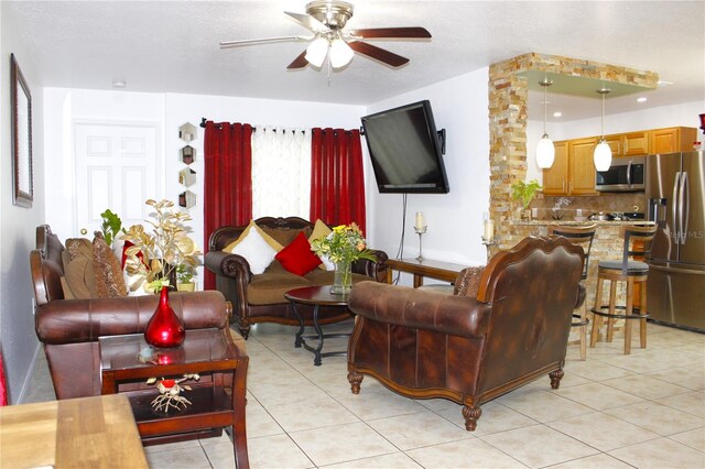 3306 E Chelsea St, Tampa, FL 33610 - living room featuring baseboards, a ceiling fan, and light tile patterned flooring