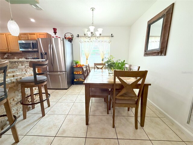 3306 E Chelsea St, Tampa, FL 33610 - dining room featuring an inviting chandelier, baseboards, light tile patterned floors, and visible vents