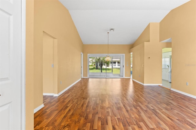 1046 Almondwood Dr, Trinity, FL 34655 - interior space featuring visible vents, wood finished floors, high vaulted ceiling, and baseboards