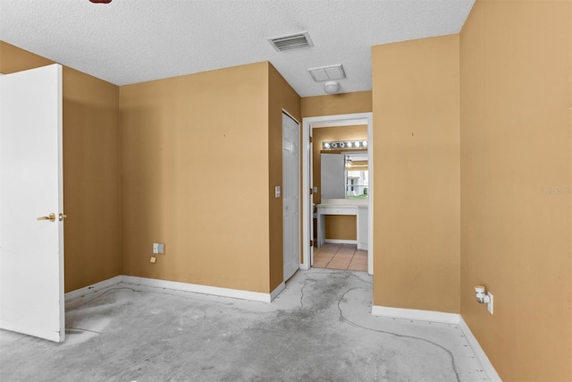1046 Almondwood Dr, Trinity, FL 34655 - empty room with baseboards, visible vents, and a textured ceiling