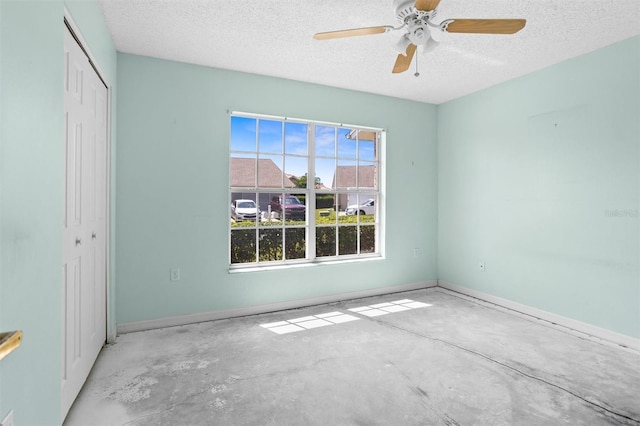 1046 Almondwood Dr, Trinity, FL 34655 - unfurnished bedroom with a textured ceiling, unfinished concrete floors, baseboards, and a closet