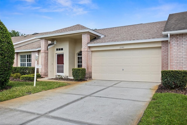 1046 Almondwood Dr, Trinity, FL 34655 - view of front of house with a garage, brick siding, driveway, and roof with shingles