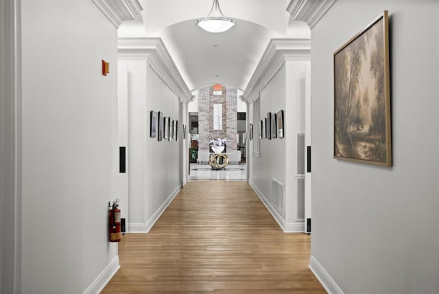 1046 Almondwood Dr, Trinity, FL 34655 - hallway with lofted ceiling, visible vents, wood finished floors, and baseboards