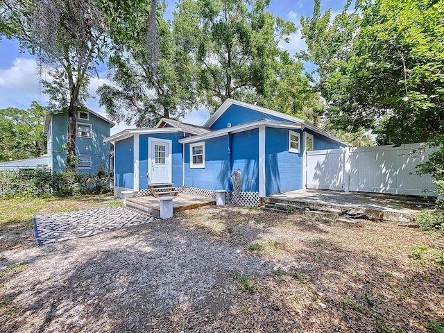 view of front facade with a deck and fence