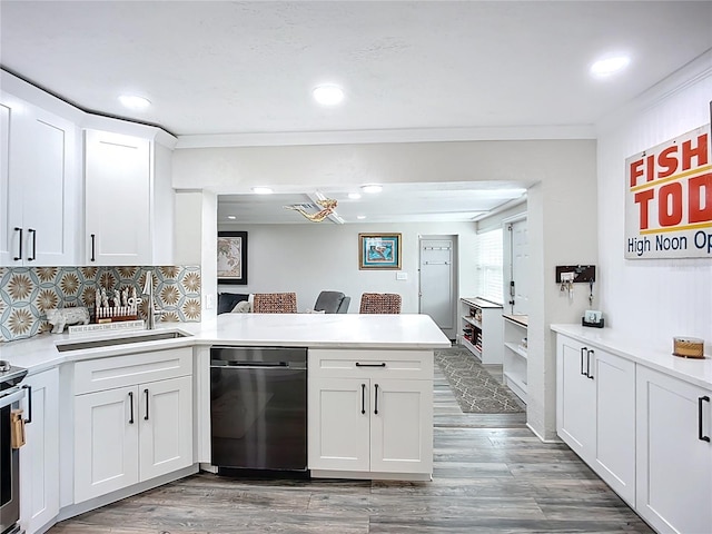 4231 8th St N, Saint Petersburg, FL 33703 - kitchen with a peninsula, wood finished floors, white cabinets, appliances with stainless steel finishes, and recessed lighting