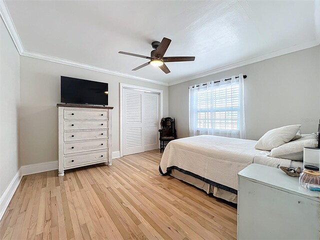 4231 8th St N, Saint Petersburg, FL 33703 - bedroom with baseboards, ornamental molding, light wood finished floors, and a closet