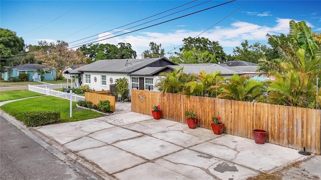 4231 8th St N, Saint Petersburg, FL 33703 - bungalow-style home with a front yard, a patio area, and a fenced front yard