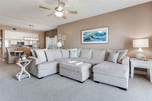 425 150th Ave Unit 2301, Madeira Beach, FL 33708 - living room with light colored carpet and ceiling fan