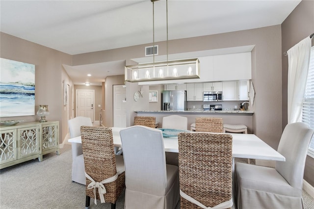 425 150th Ave Unit 2301, Madeira Beach, FL 33708 - dining room with baseboards and light carpet