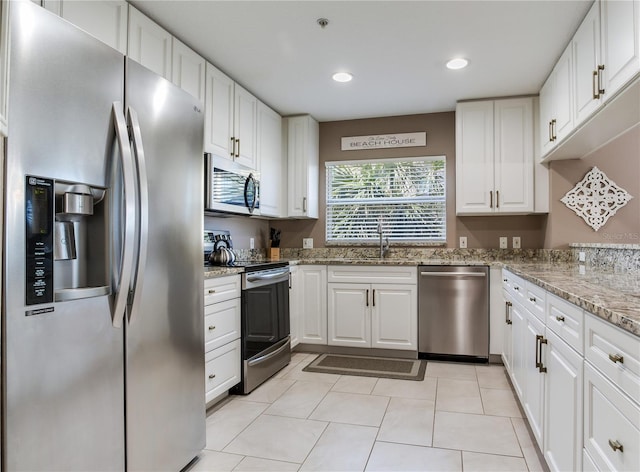 425 150th Ave Unit 2301, Madeira Beach, FL 33708 - kitchen featuring stainless steel appliances, white cabinetry, recessed lighting, light stone countertops, and light tile patterned floors