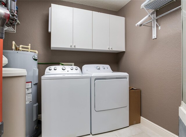 425 150th Ave Unit 2301, Madeira Beach, FL 33708 - laundry area featuring electric water heater, washer and clothes dryer, and cabinet space