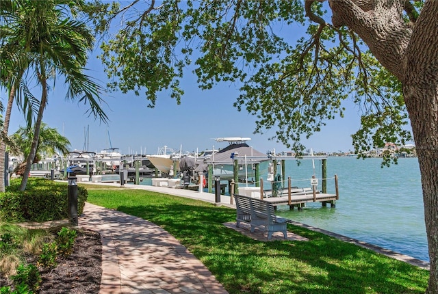 425 150th Ave Unit 2301, Madeira Beach, FL 33708 - dock area with boat lift, a yard, and a water view