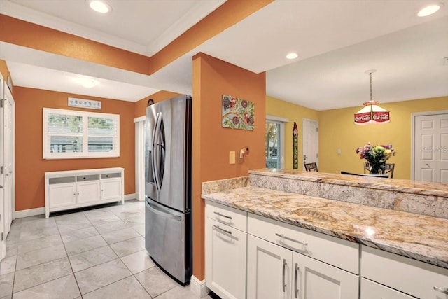 50 Balsam Dr, Oldsmar, FL 34677 - kitchen featuring freestanding refrigerator, recessed lighting, white cabinets, baseboards, and light stone countertops